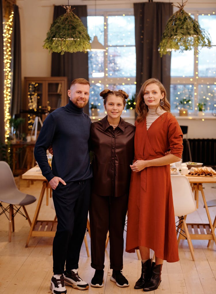 Family Smiling While Looking At The Camera