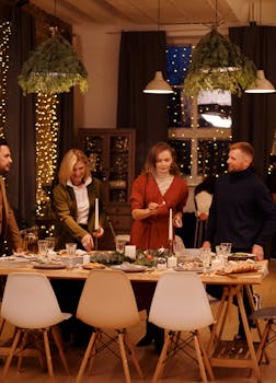 A festive and cozy Christmas dinner party with friends gathering around a beautifully decorated table.