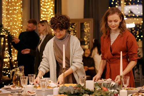 Two Women Preparing Table Set-Up for Christmas Dinner