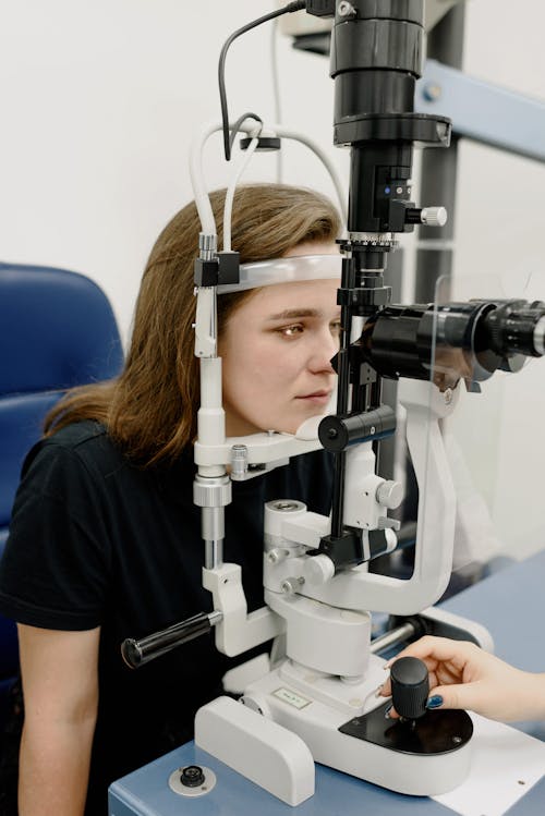 Woman testing vision on machine in clinic