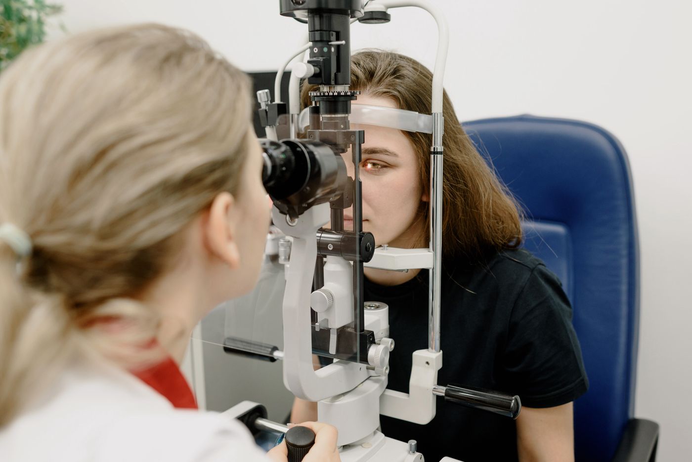 Eye-care professional performing a detailed slit-lamp examination before vision correction