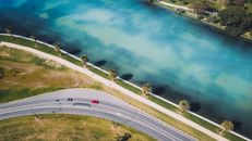 Cars on a Road Near a Body of Water