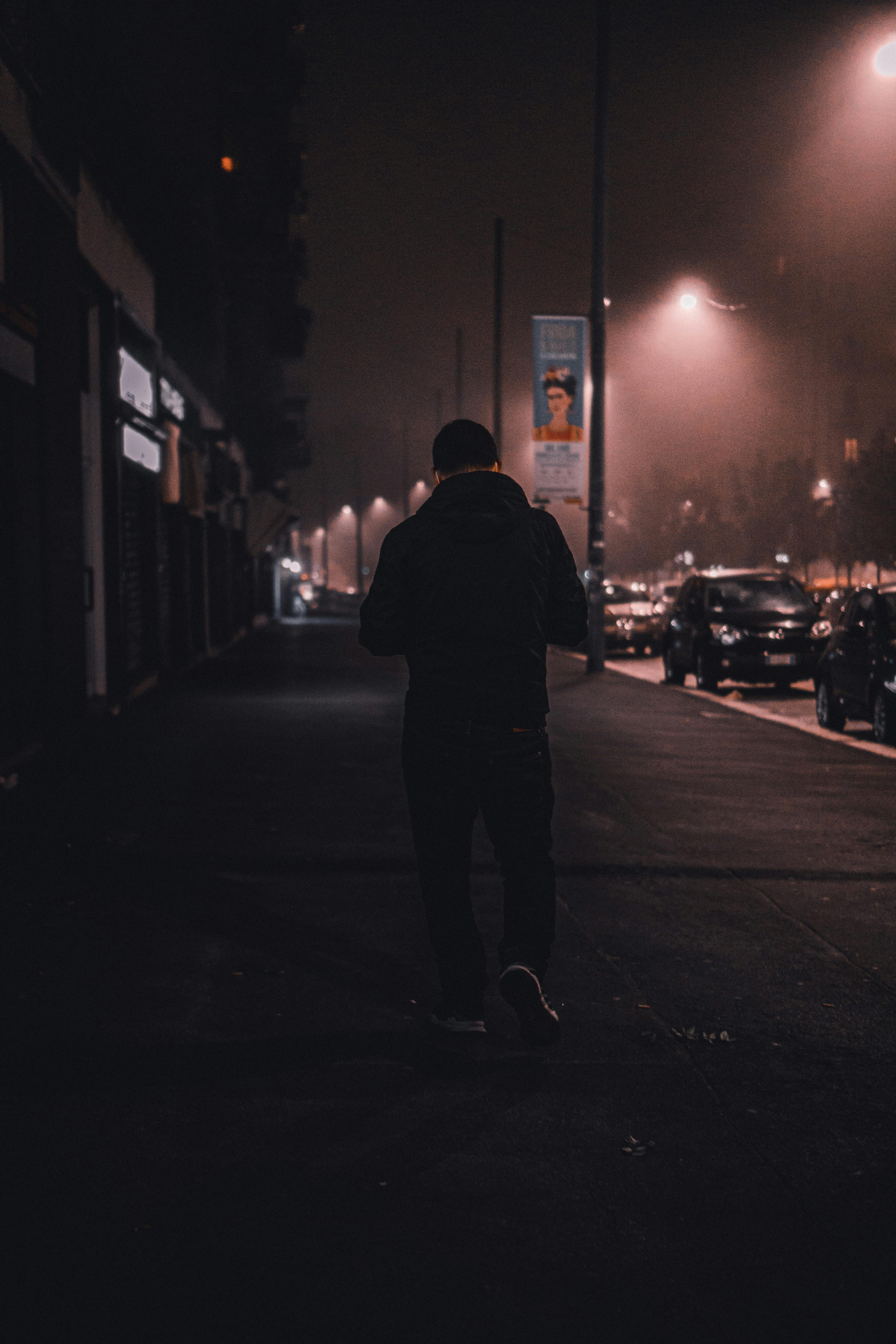 man walking at night