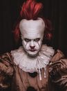 A Person Costumed as Pennywise Seriously Looking at the Camera