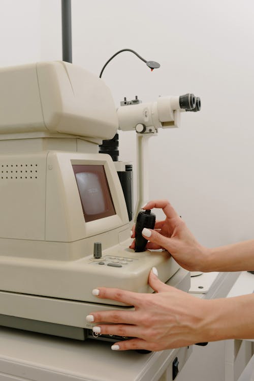 Doctor working with topography machine in clinic