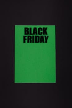 Green paper on black background with bold 'Black Friday' text for sales promotion.