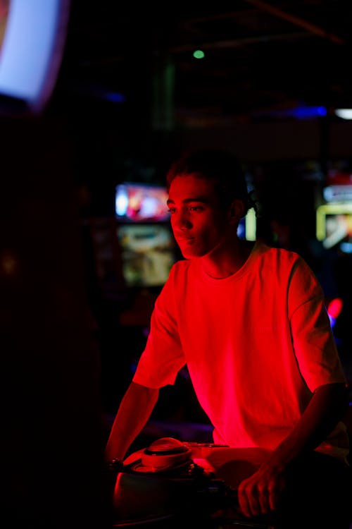 A Man Playing in an Arcade
