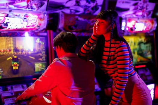 Couple engaged in vibrant arcade gaming with neon lights and racing excitement.