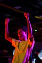 Happy Man in Yellow Crew Neck T-shirt Raising his Hands