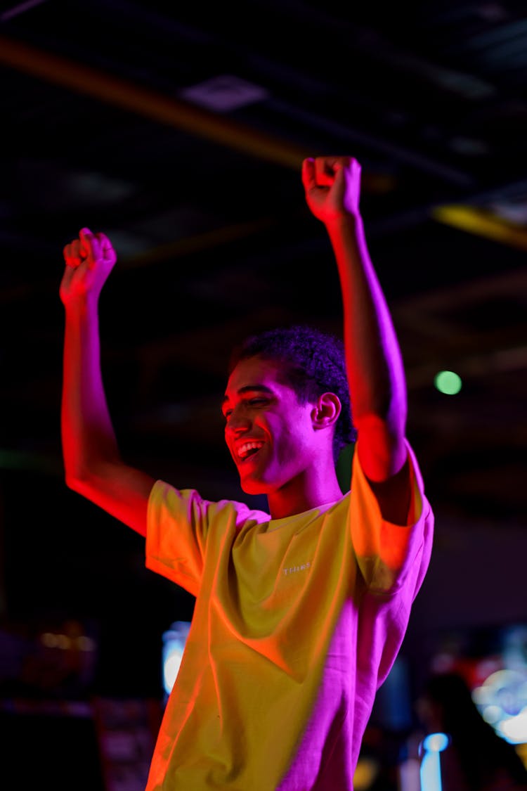 Happy Man In Yellow Crew Neck T-shirt Raising His Hands 