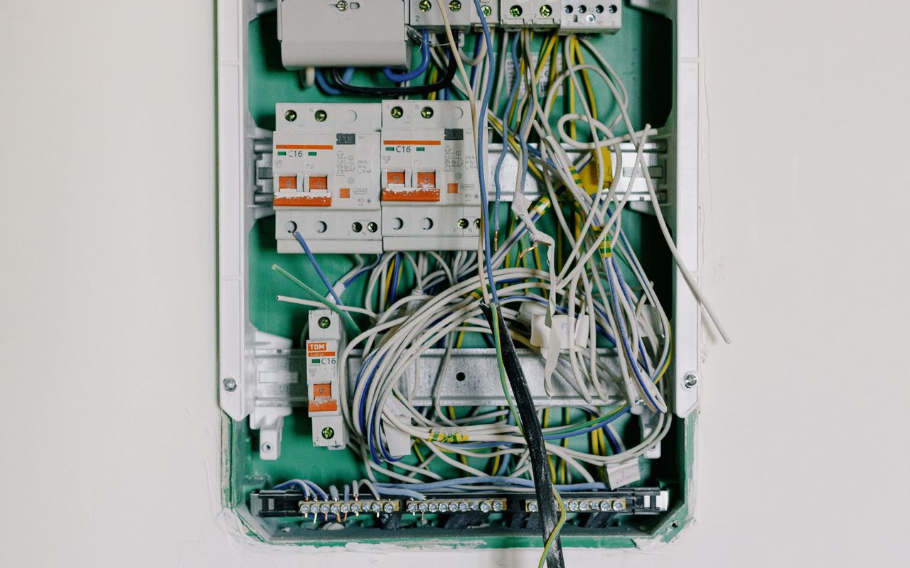 Open consumer unit/distribution board on white wall