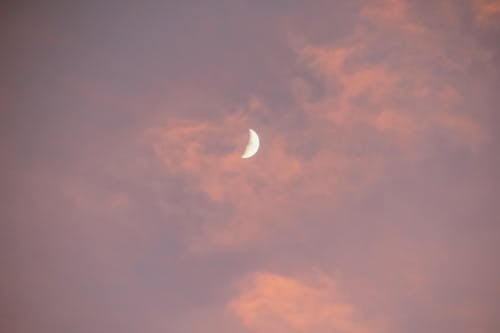 Free Shiny moon in bright cloudy sky at sunset Stock Photo