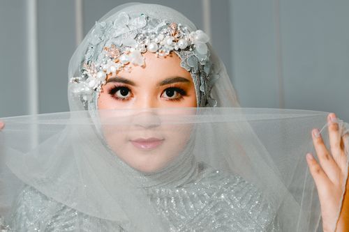 Free Beautiful portrait of a bride wearing an ornate hijab with a delicate veil. Stock Photo