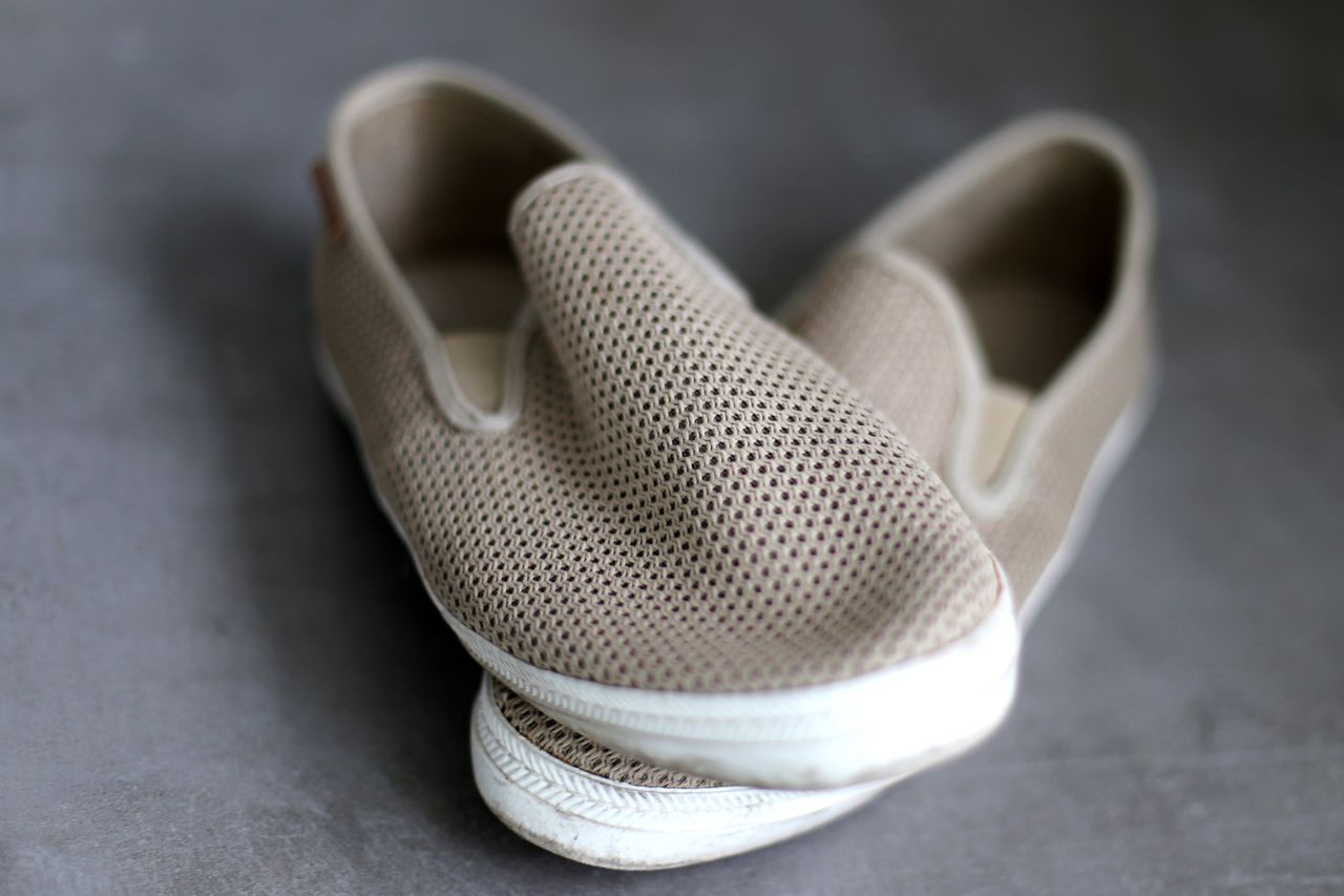 Pair of beige breathable mesh slip-on trainers
