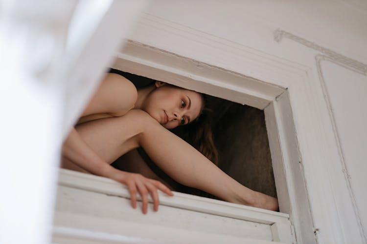 A Woman Sitting On The Ceiling