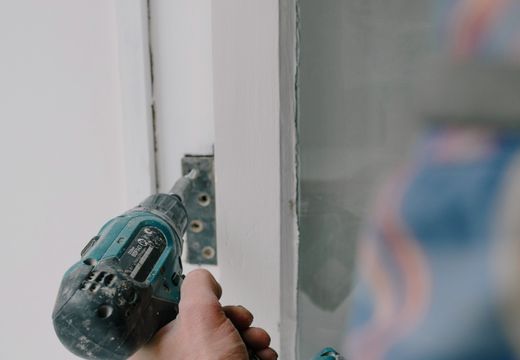 Installing a window with a screwdriver during a renovation