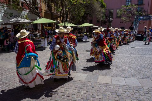 Free Colorful dancers performing traditional Mexican folklore in city streets, capturing vibrant culture and costumes. Stock Photo