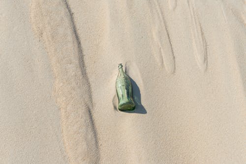 Green Bottle on Sand