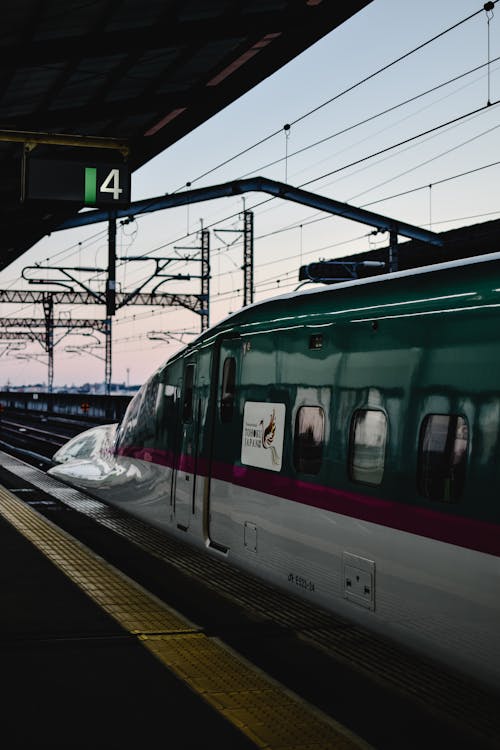 White and Green Train on Rail Tracks