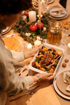 A cozy Christmas dinner setting featuring roasted vegetables and festive decorations.