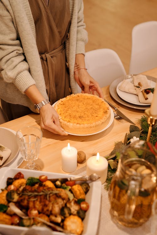 Person Serving a Cake for Christmas Dinner