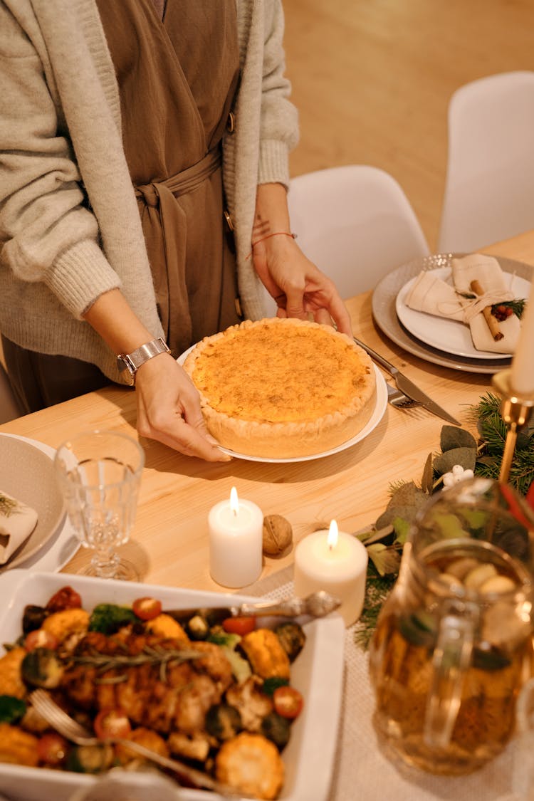 Person Serving A Cake For Christmas Dinner