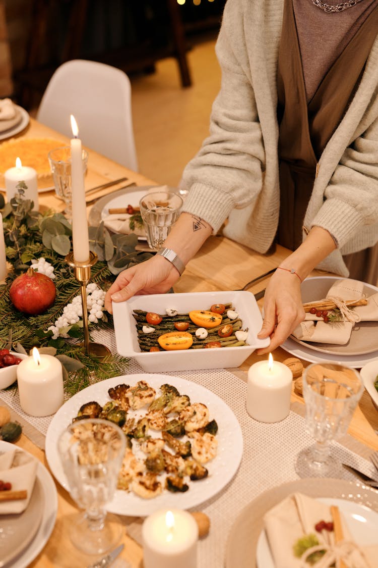 Person Serving A Food For Christmas Dinner