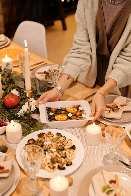 Free Warm and inviting Christmas dinner table with delicious homemade dishes and festive decor. Stock Photo