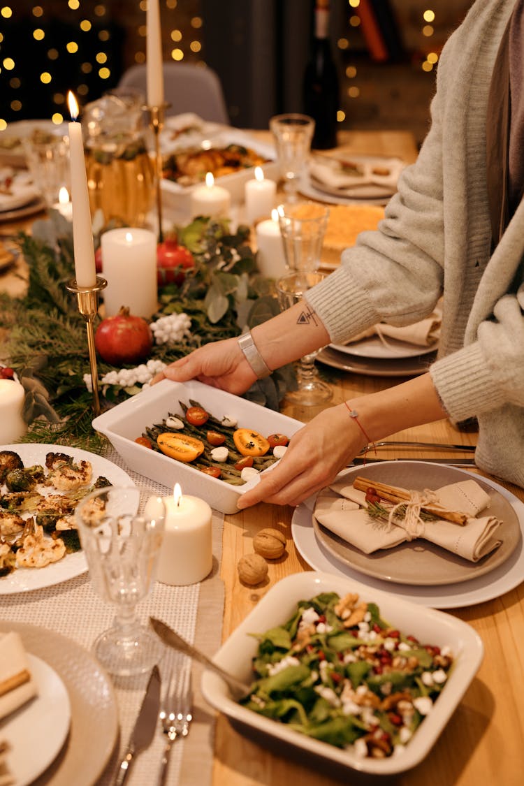 Person Serving A Food For Christmas Dinner