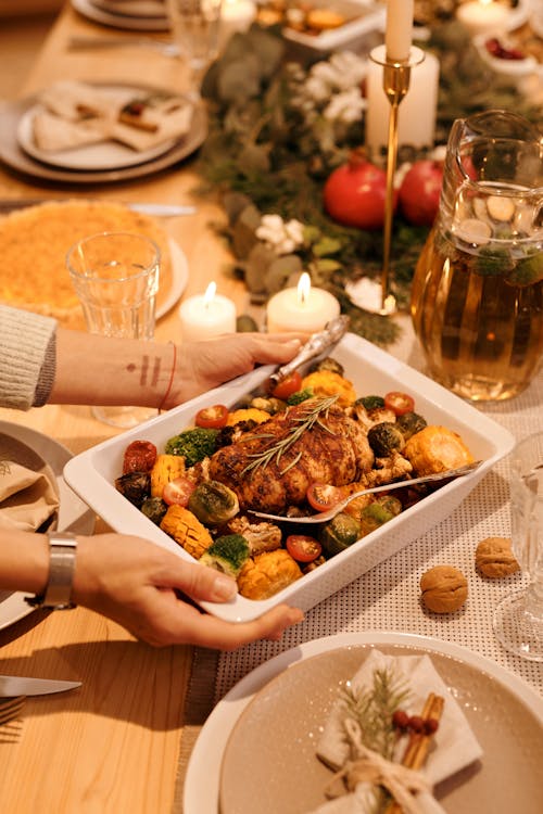 Free Person Serving a Food on Christmas Dinner Stock Photo