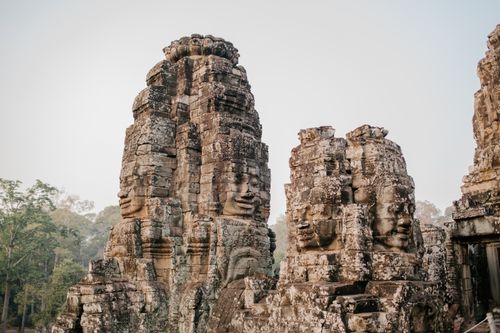 Free Ancient stone faces of Bayon Temple, a historic Khmer landmark in Cambodia. Stock Photo