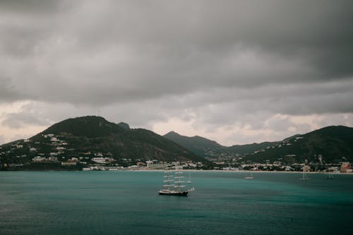 White Boat on Sea Under Gloomy Sky