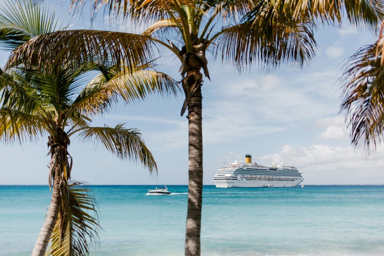 A White Ship And A Boat Sailing On The Ocean