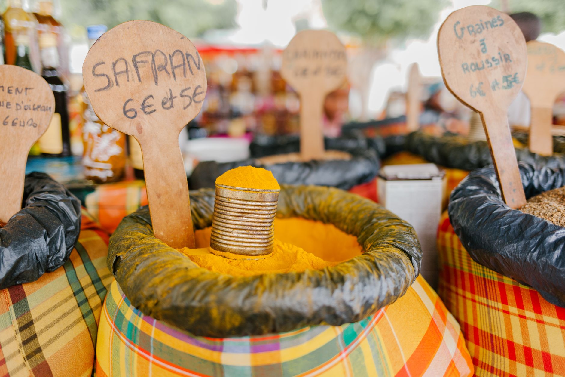 Vibrant spice market with sacks of colorful saffron and other spices displayed outdoors.