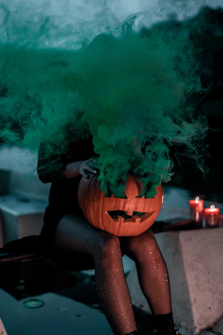 Faceless Woman With Jack Lantern And Colored Smoke In Twilight