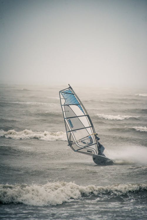 Person Wind Surfing on the Beach