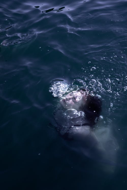 A Photo of a Woman Swimming Underwater
