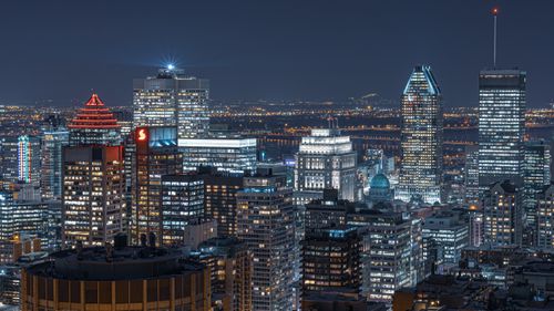 Free A breathtaking aerial view of Montreal's skyline at night showcasing modern architecture and vibrant city lights. Stock Photo