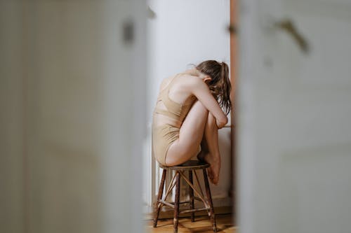 Free Woman in her Underwear Sitting on a Stool Stock Photo