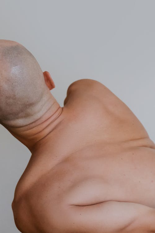 Free A Bald Person Stretching His Back Stock Photo