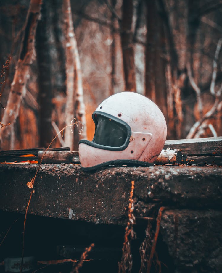 An Old Helmet On A Concrete Surface