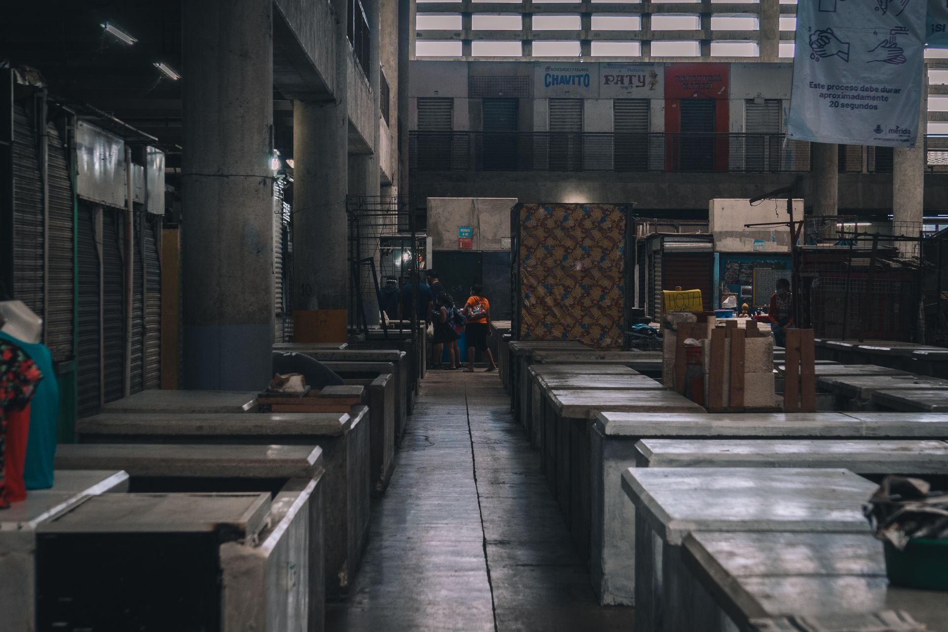 Empty, dusty market stalls under an overcast sky
