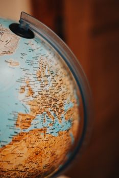 A detailed close-up of a globe with focus on Europe, highlighting geographic features.
