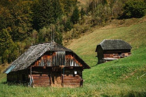 Brown Wooden Barn on Green Grassland