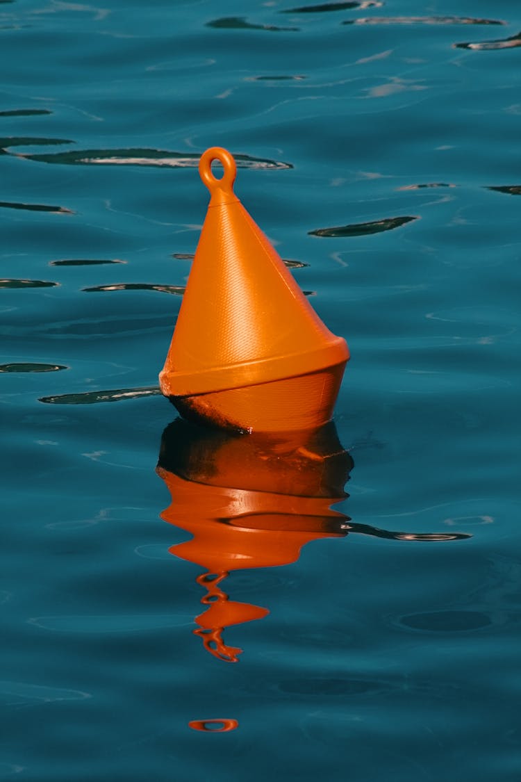 Orange Warning Buoy Floating In Water