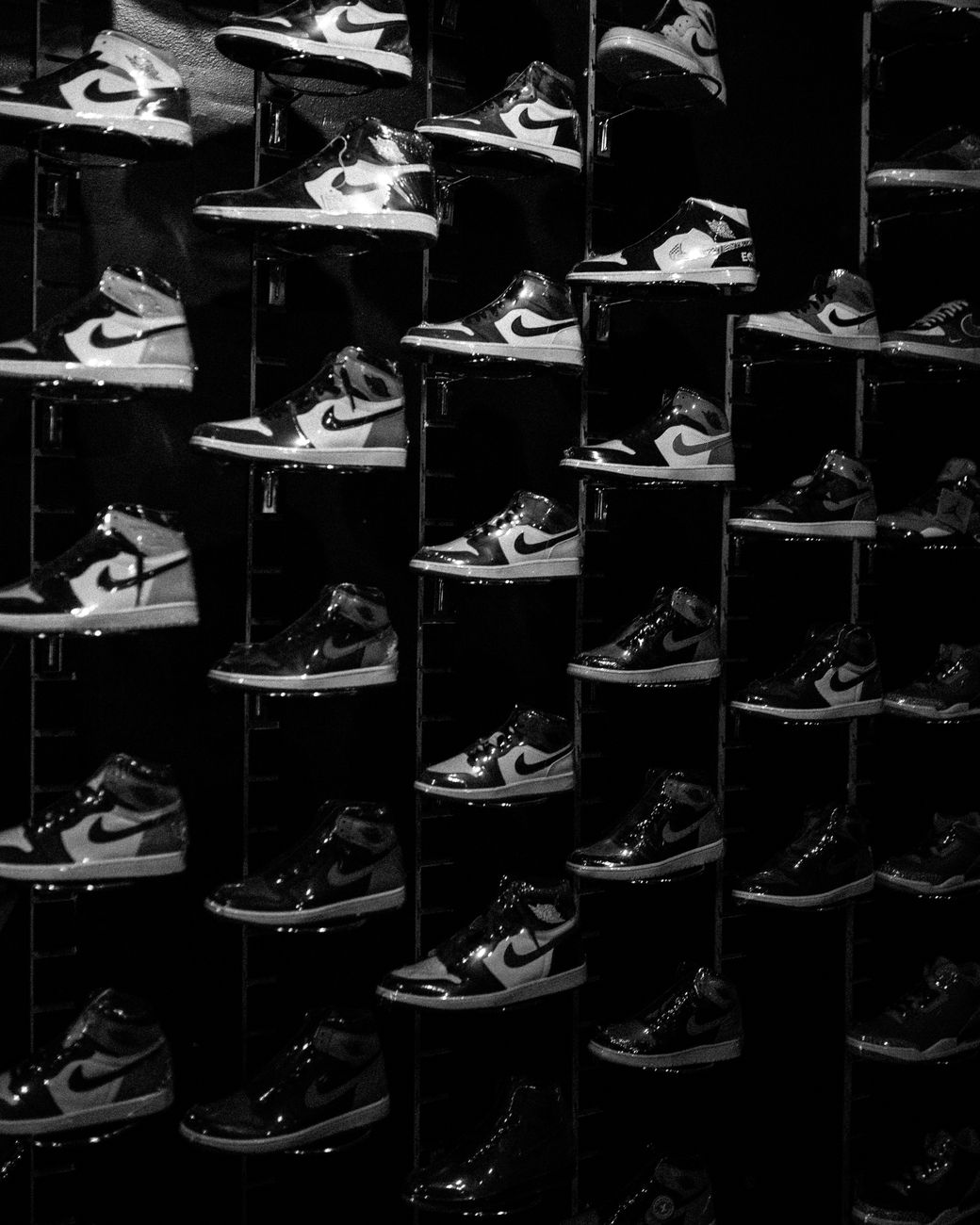 Artistic black and white photo of Nike Air Jordan sneakers prominently displayed in a store.