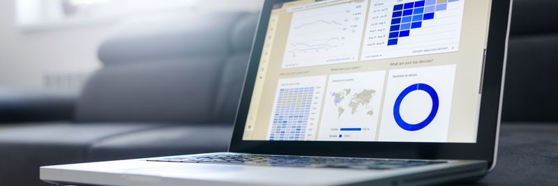 Sleek laptop showcasing data analytics and graphs on the screen in a bright room.