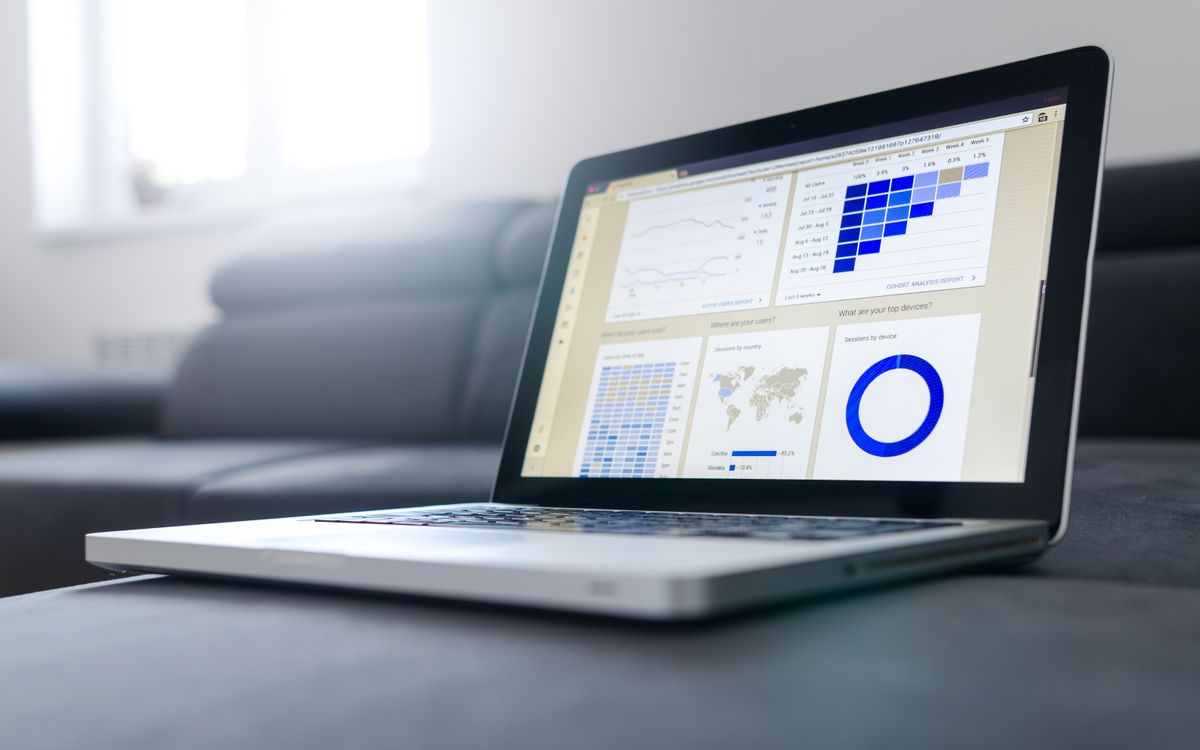 Sleek laptop showcasing data analytics and graphs on the screen in a bright room.