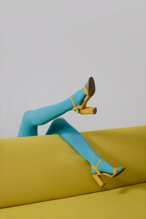 A Person in Blue Stockings and Yellow Shoes · Free Stock Photo