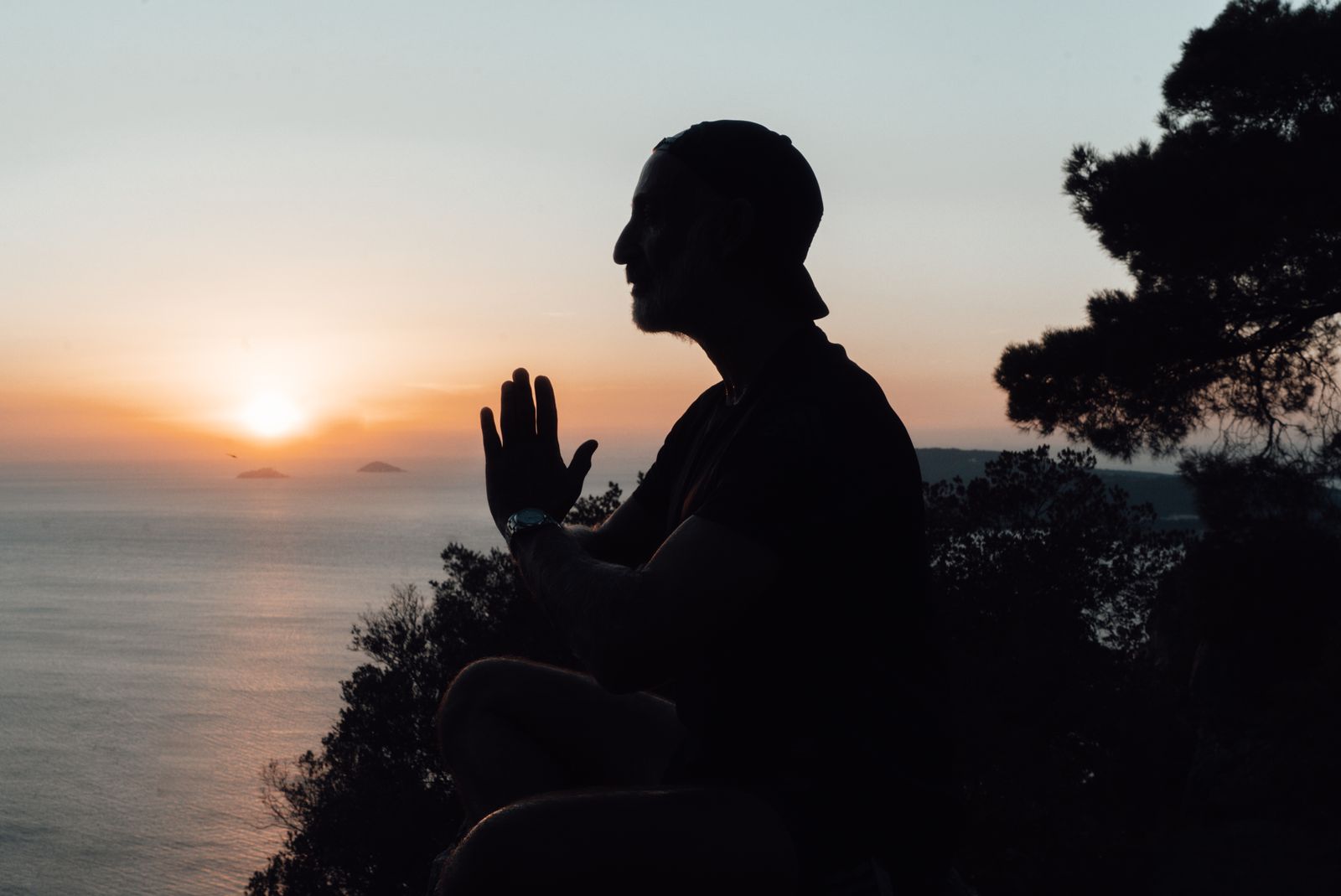 Person doing a calming evening yoga stretch at home in the evening light